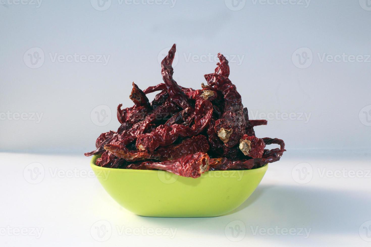 Byadgi Red Dry Chili or Bedgi Mirch, Lal Mirchi on white background. It is a famous variety of chili mainly grown in the Indian state of Karnataka. photo