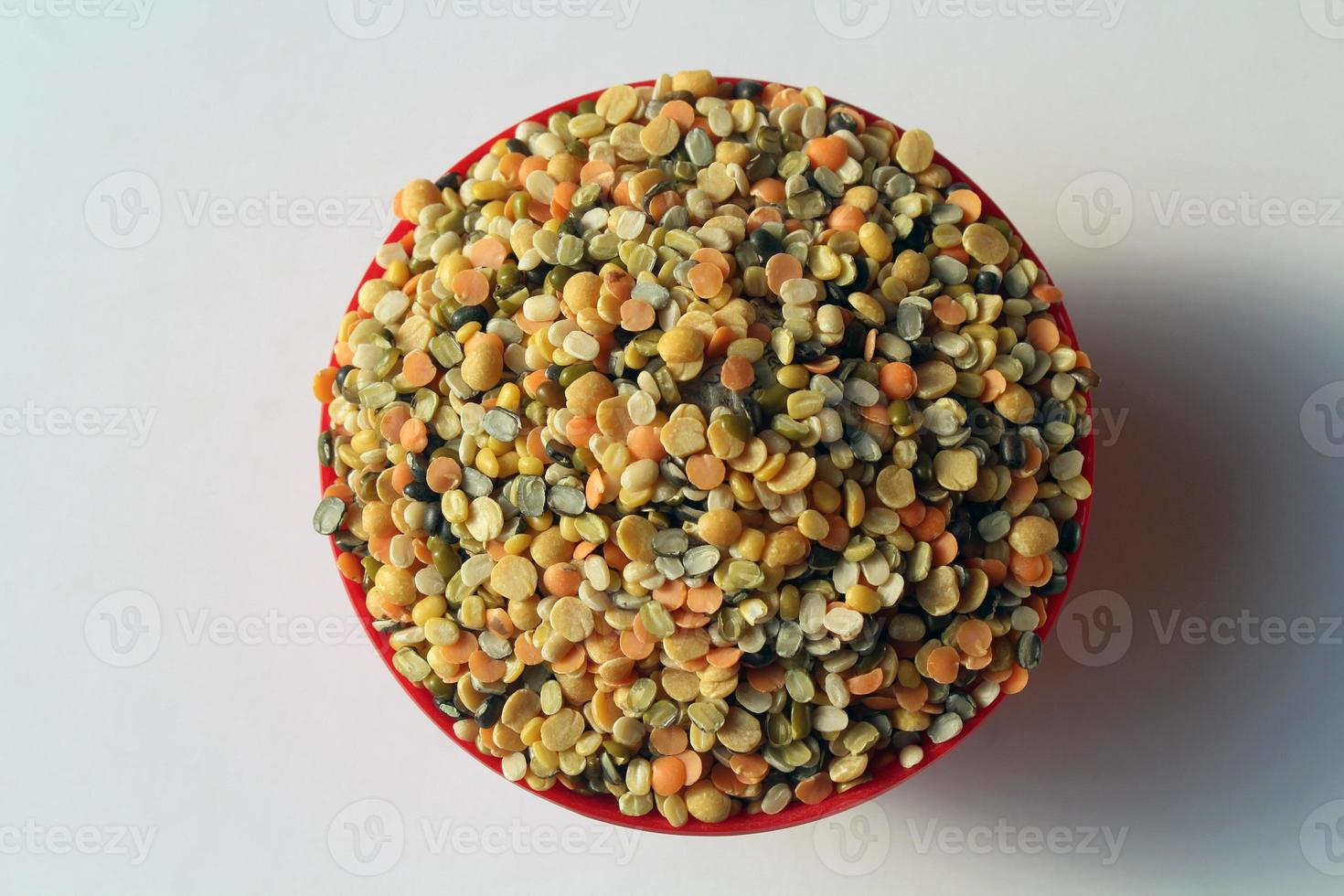 A bowl of mixed lentils that are widely used in India. Lentils are Red lentil, Mung bean, Black gram, Pigeon pea, and split Chickpea. photo