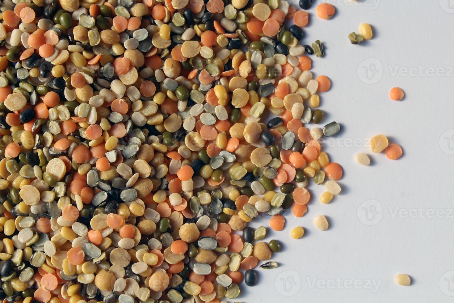 A bowl of mixed lentils that are widely used in India. Lentils are Red lentil, Mung bean, Black gram, Pigeon pea, and split Chickpea. photo