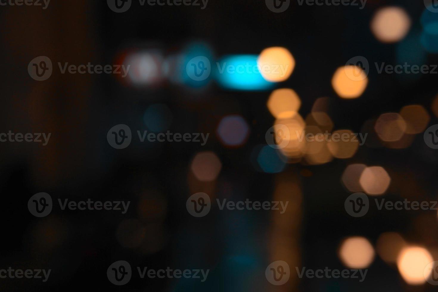 Abstract gold, orange, blue bokeh texture on black background with copy space photo