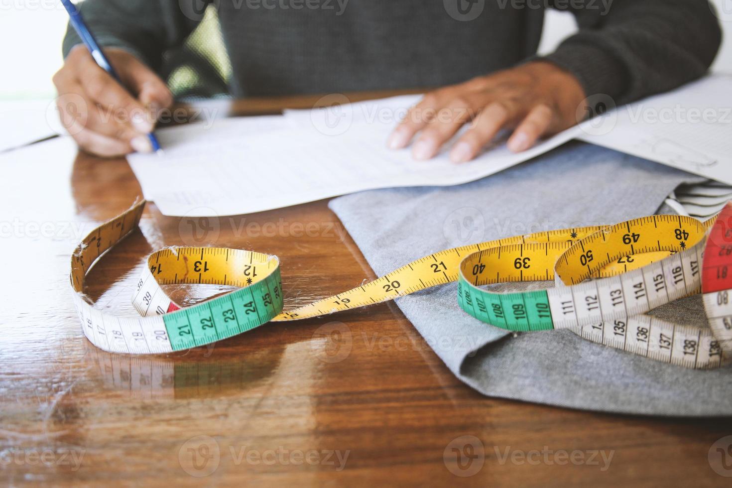 Male fashion designer is working in his workshop. On process of creating new clothes collection. photo