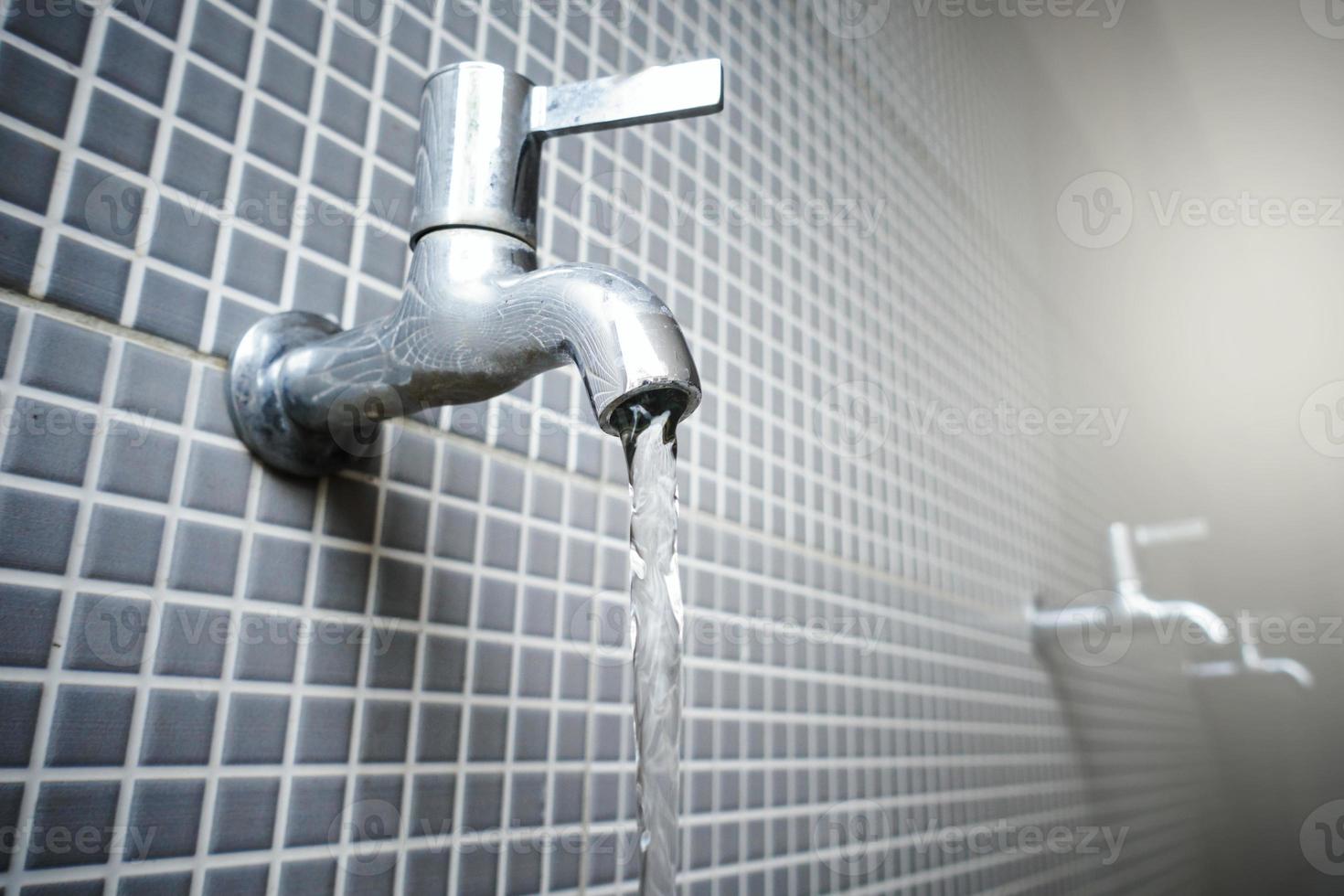 Water tap with flowing water photo