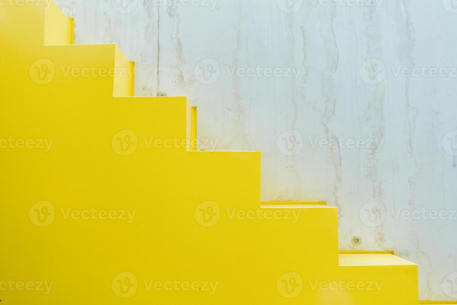 Minimalistic geometric shapes in architecture. Yellow steps and broken white walls. The concept of simplicity in design. photo