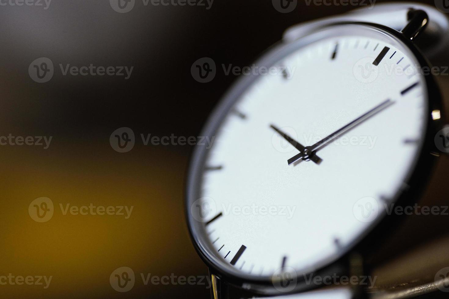 close up of analog white watch with blur backgound photo
