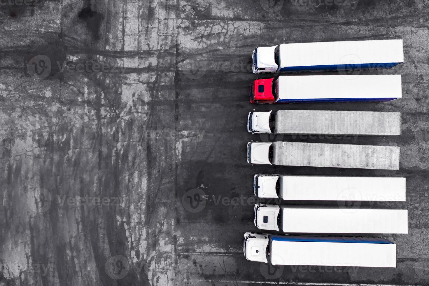 Trucks stand in a row on the asphalt background top view photo