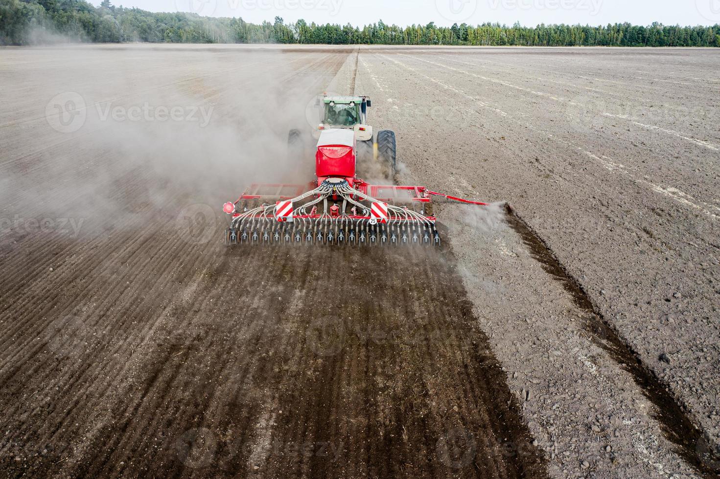 tractor sows in the field top and back view. photo
