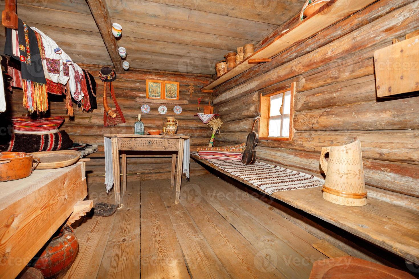 Interior space in the interior of an old Ukrainian rural hut with wooden kitchen utensils and embroidered clothes. 10.09.21. Kyiv. Ukraine. photo