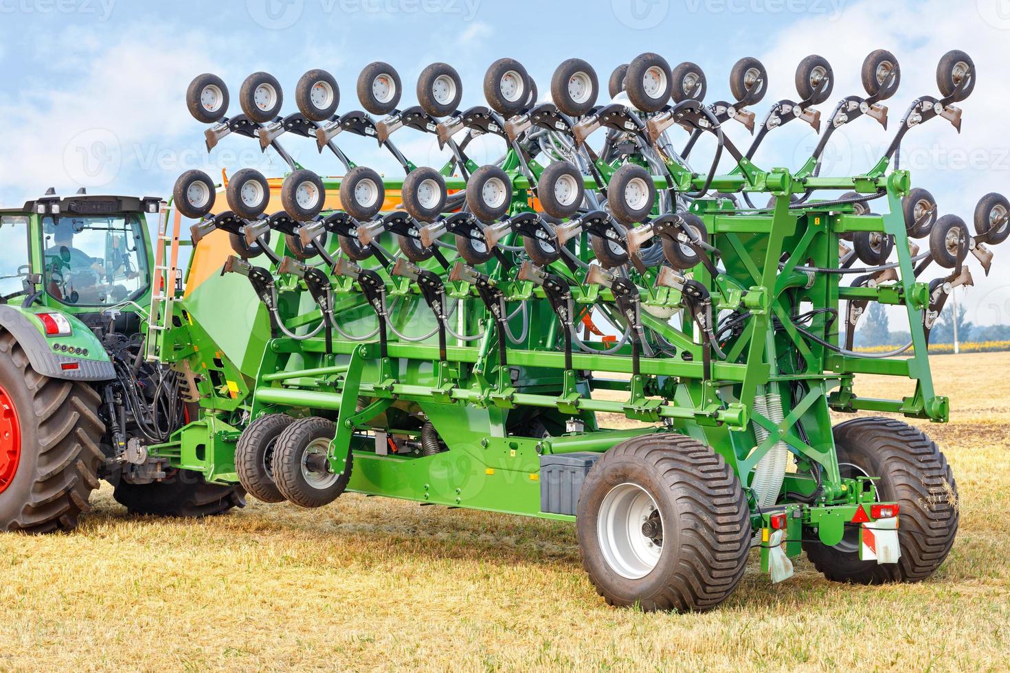 Sembradora de cereales en posición de transporte para el transporte compacto de la máquina como implemento remolcado en un tractor. foto