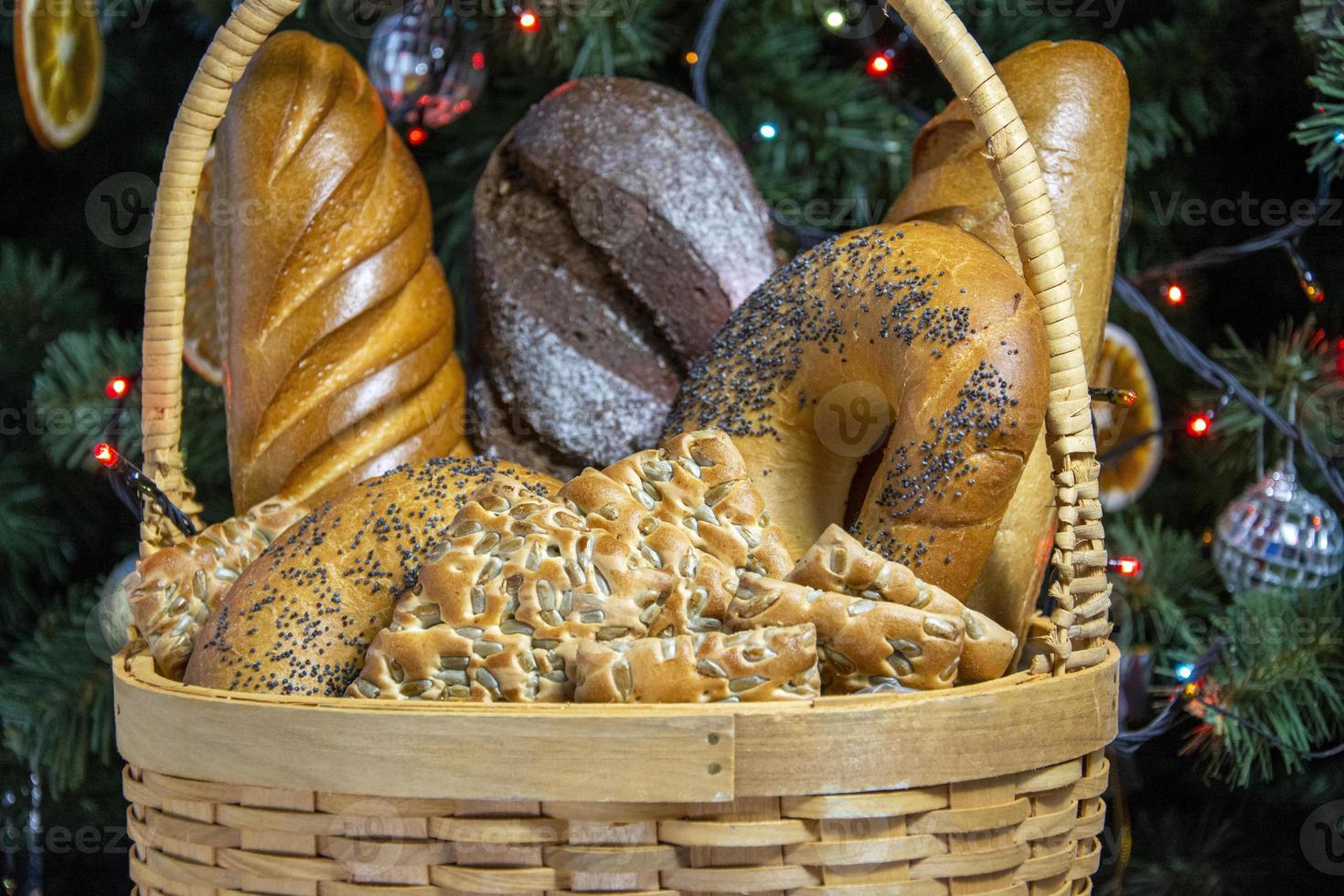 Bread in a basket close-up on the background of a Christmas tree. photo