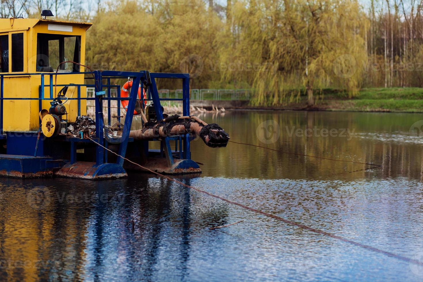 boat cleans a river photo