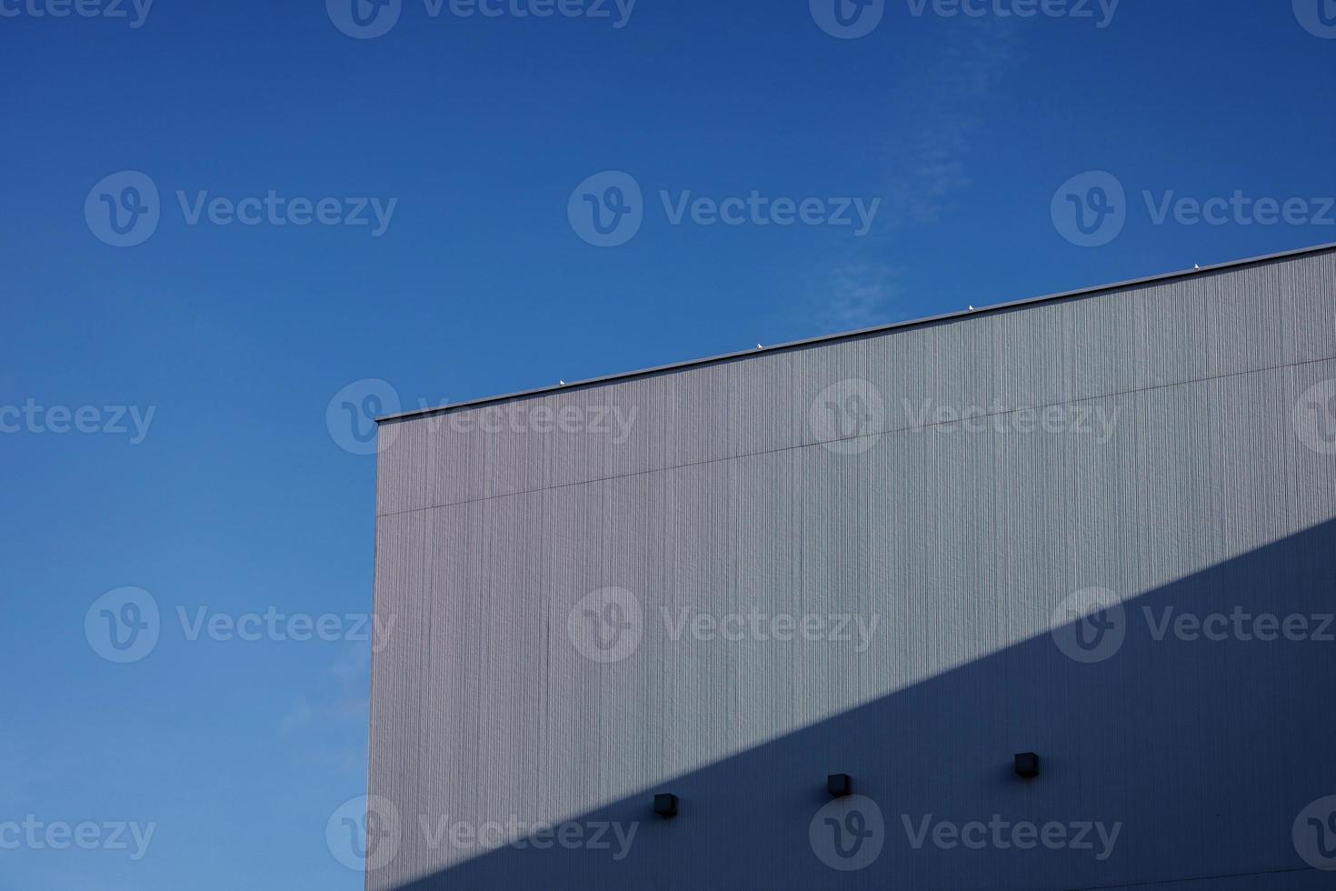 building over blue sky background photo