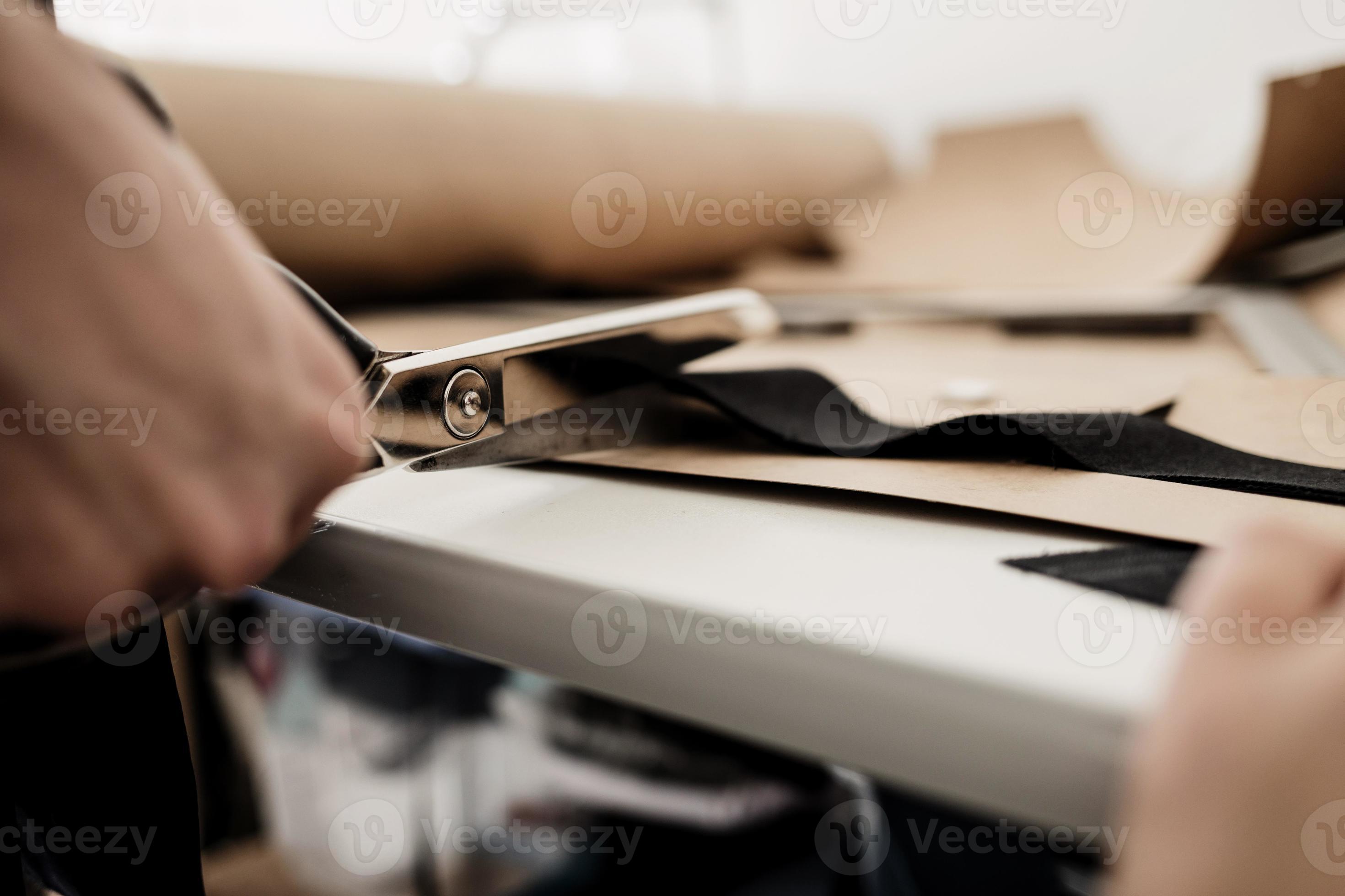 Hand with scissors cutting fabric 5693190 Stock Photo at Vecteezy