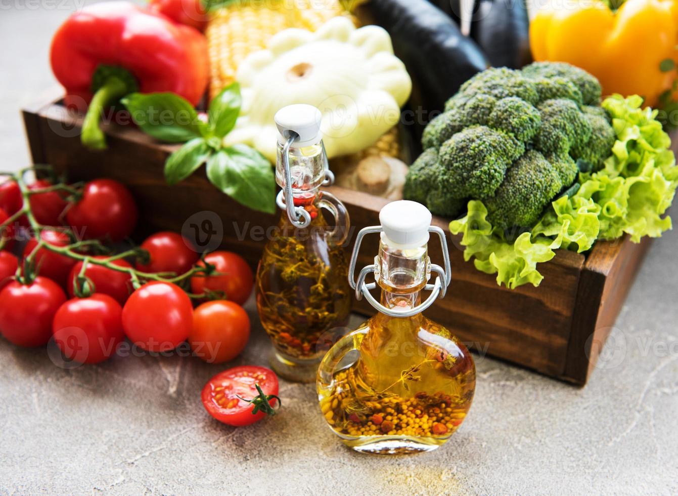 different raw vegetables and olive oil photo