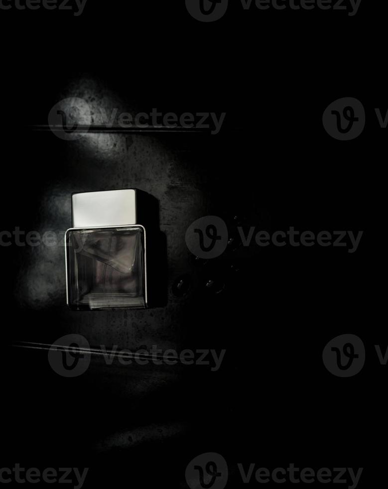 Perfume bottle on dark grungy background. photo