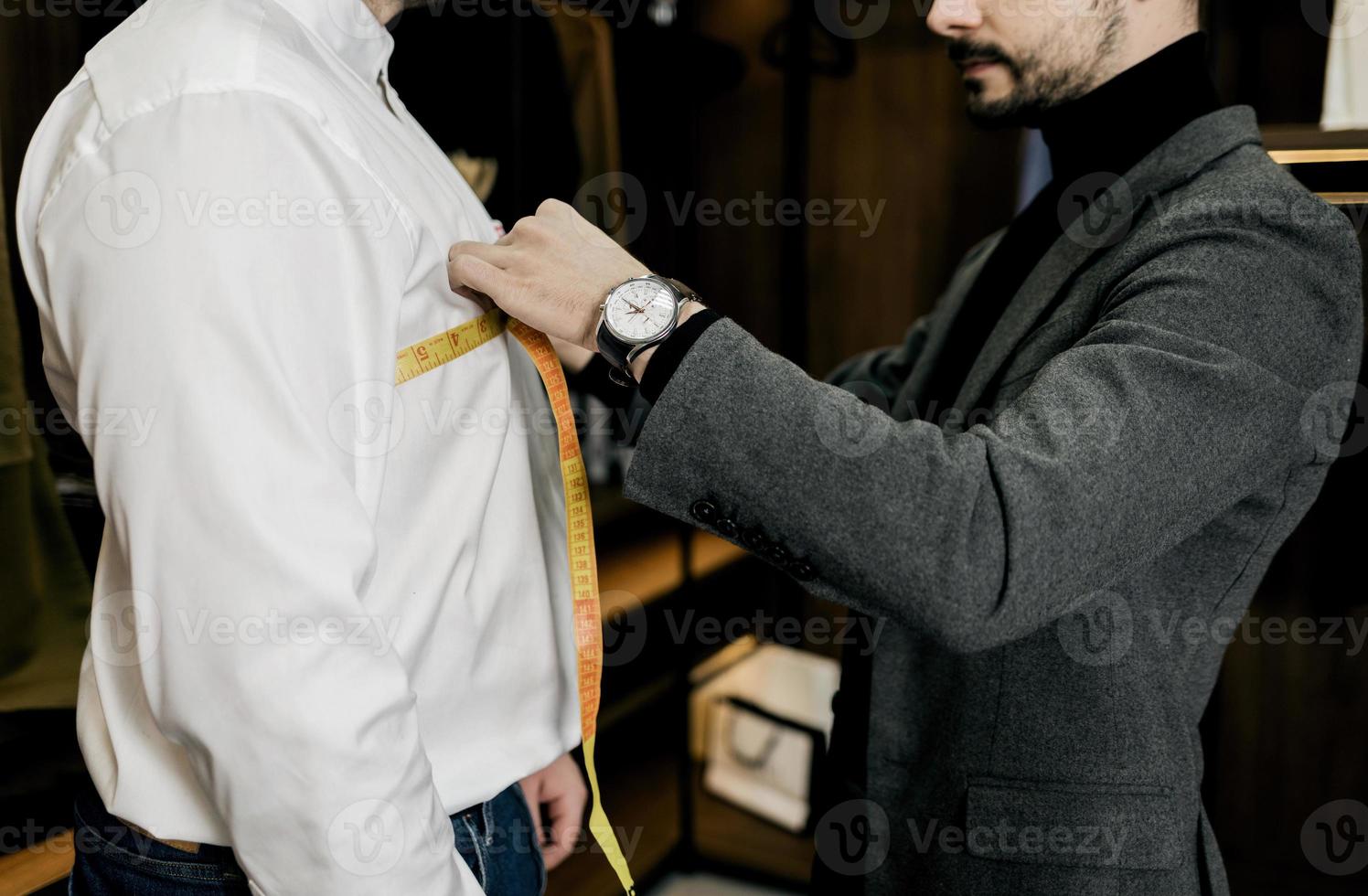 tailor taking wrist measurements from client photo