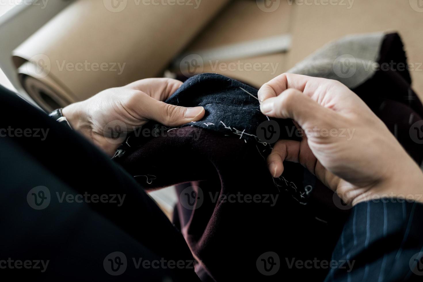 Tailor hands working in tailor shop photo