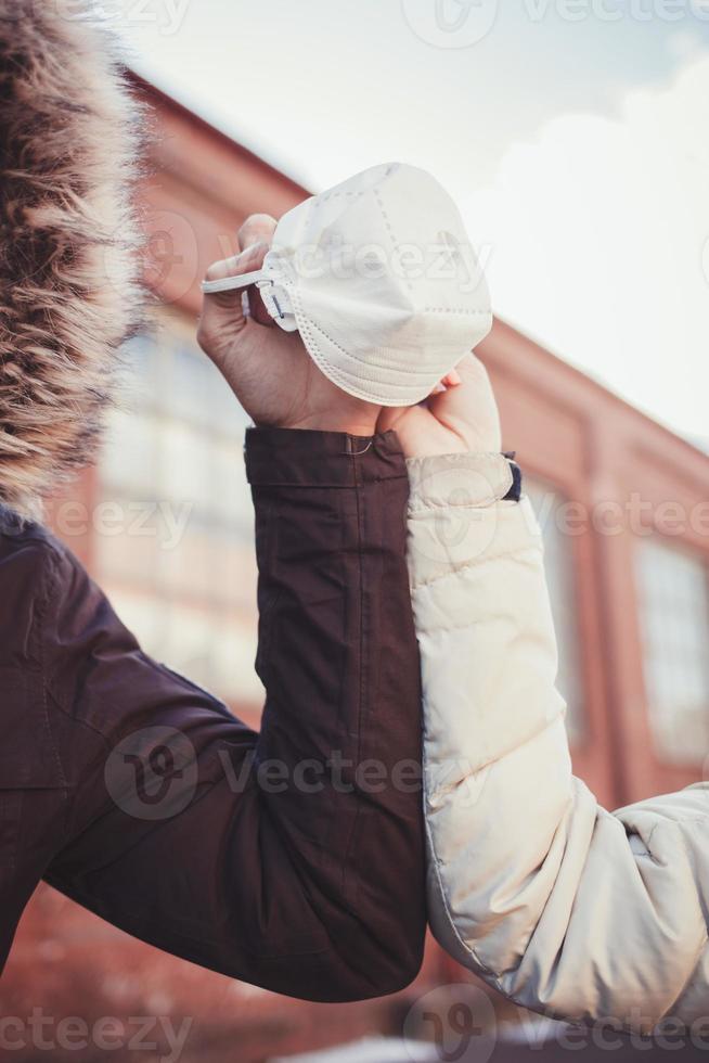 medical mask in the hands of a couple photo