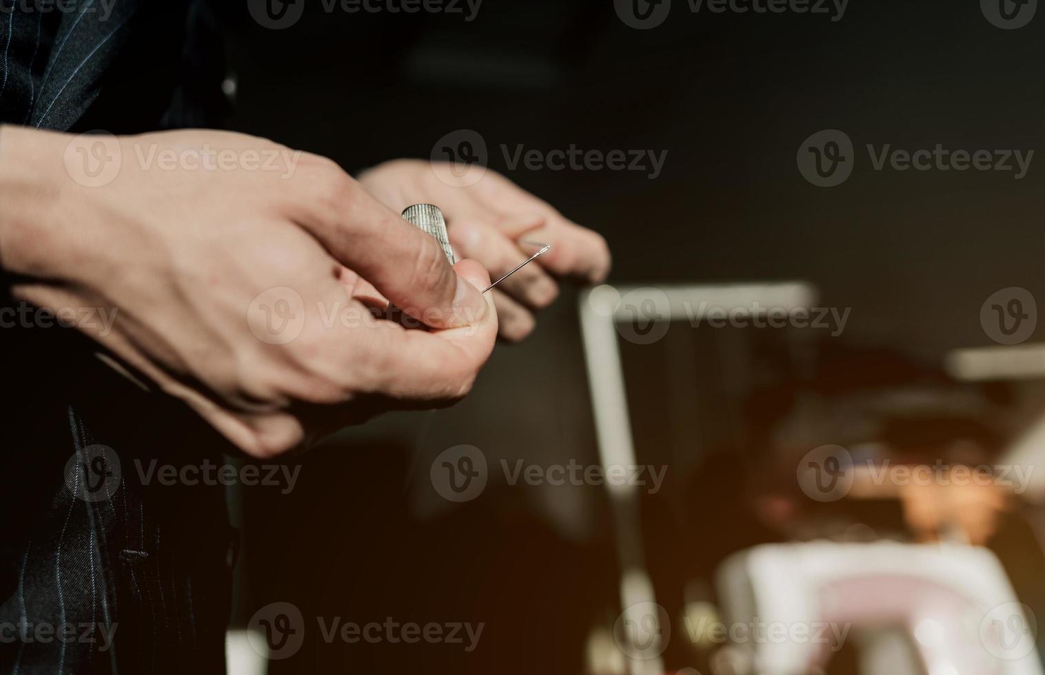 Male hands with a needle photo