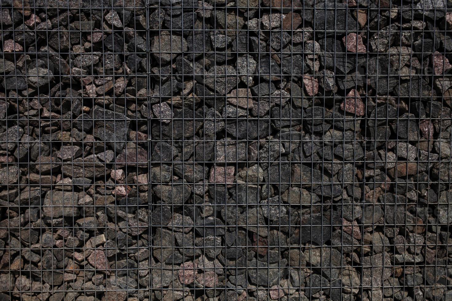 Stone wall with metal grid photo