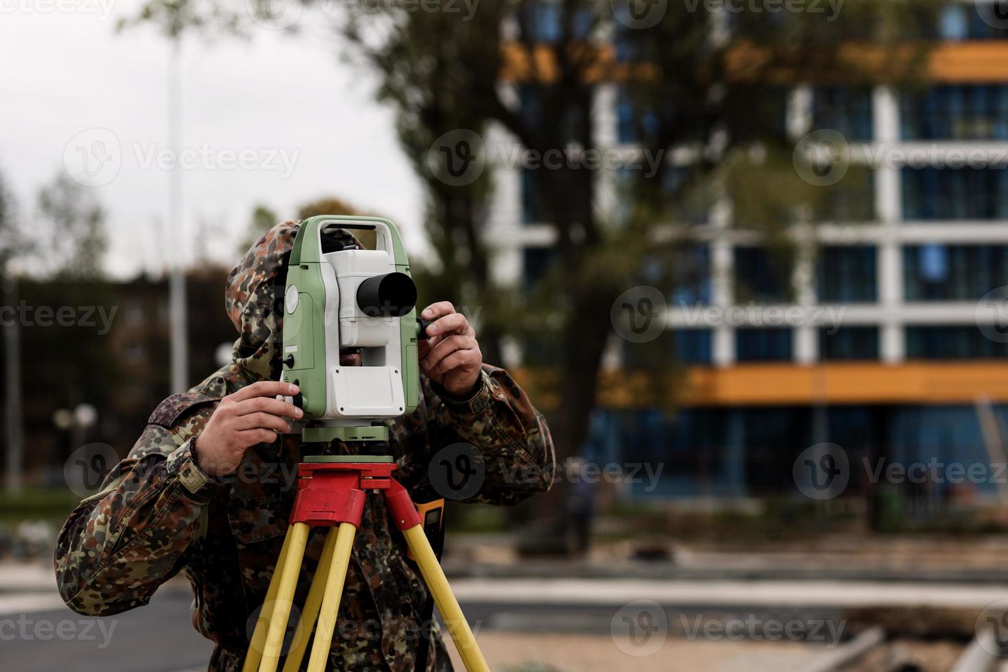 Surveyor engineer with equipment photo