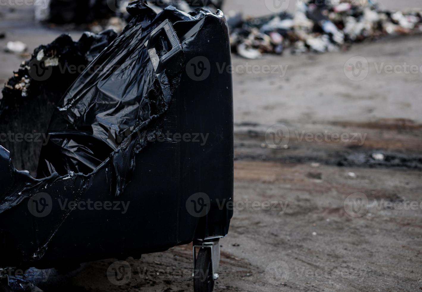 Melted trash bin in street photo