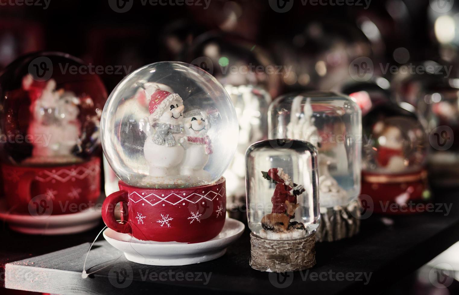 Snow globe with happy snowman photo