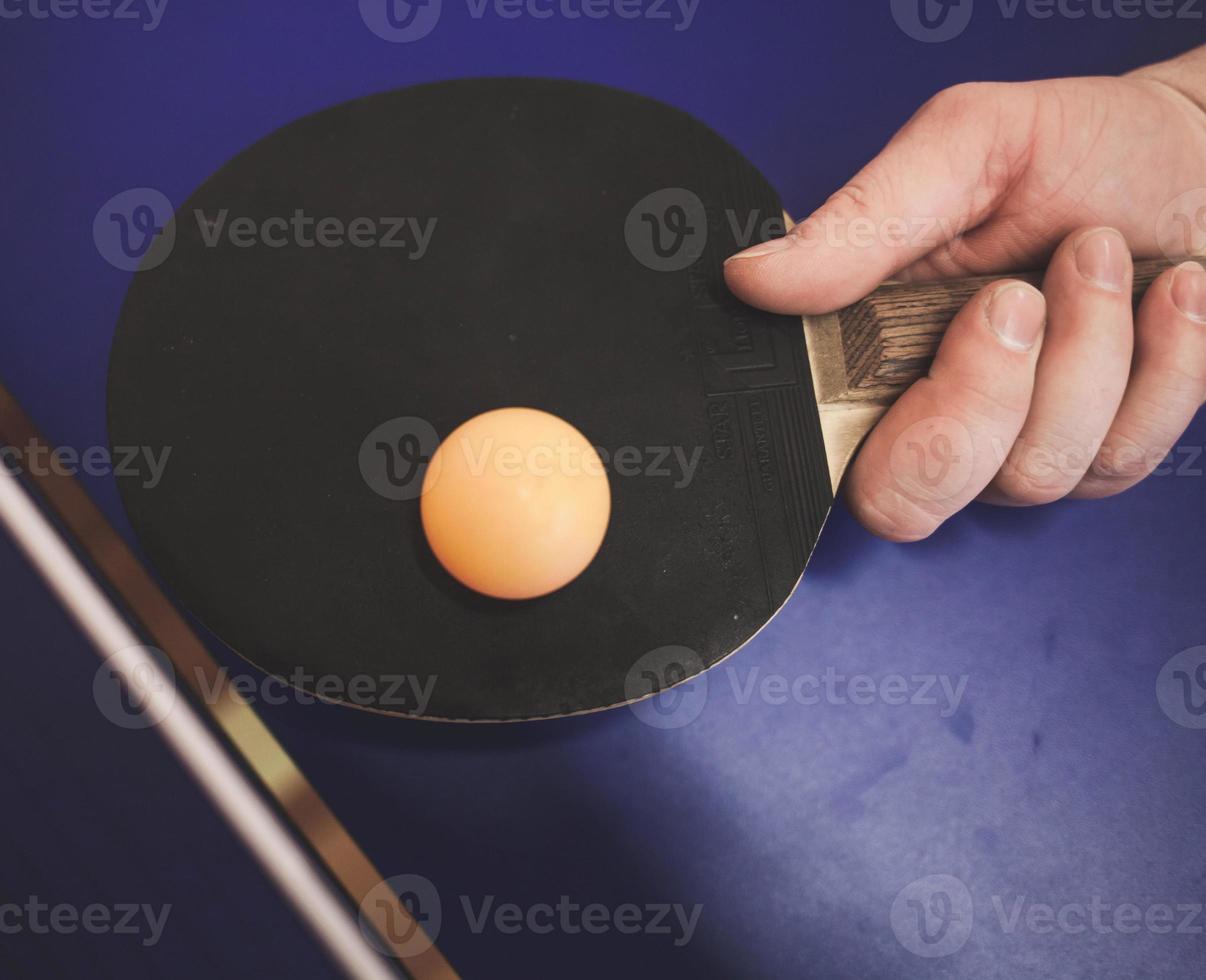 man is playing ping pong photo