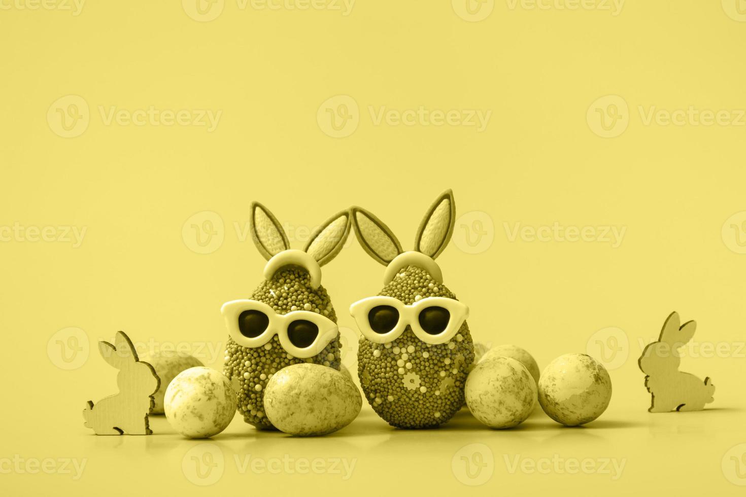 Colorful Easter egg with bunny ears and sunglasses on a blue background. Sale banner, mockup template. copy space photo