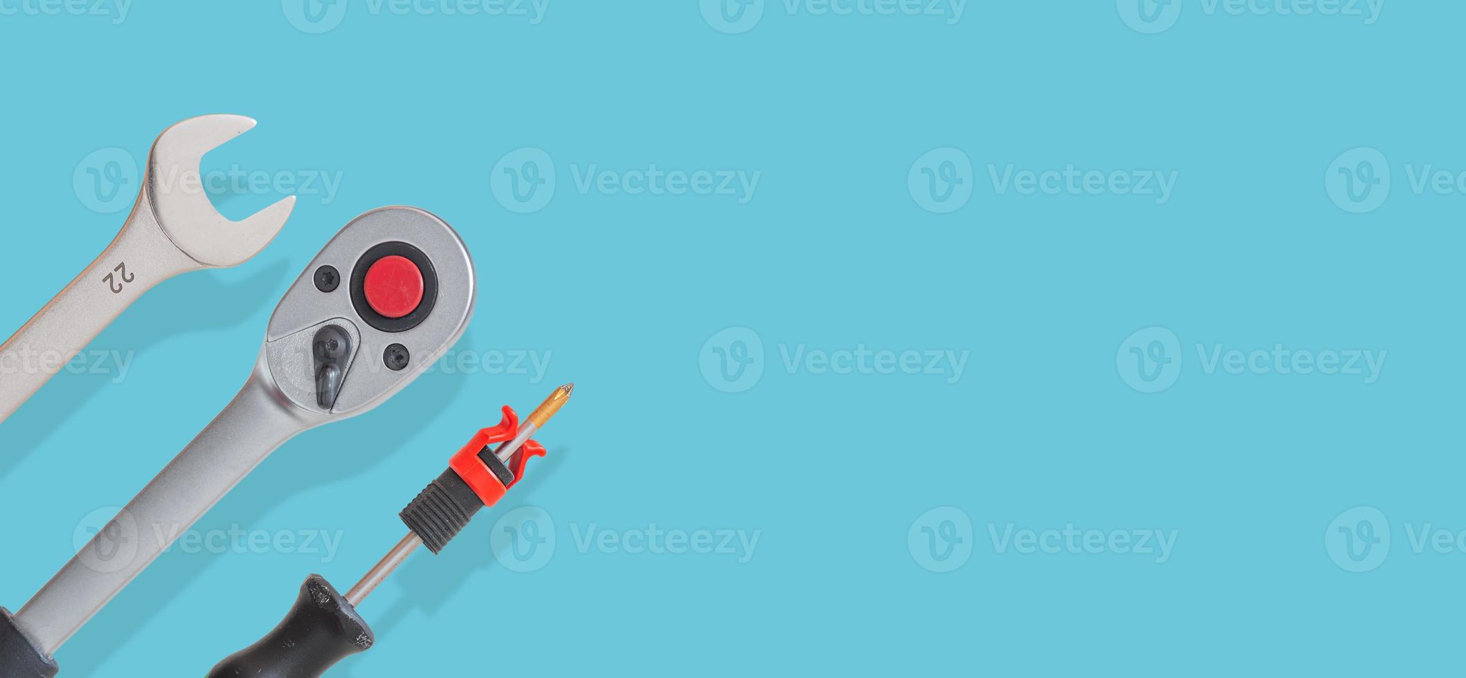 Banner with many workshop tools with shadows at solid turquoise background with copy space. Concept of hardware, gears, and workshop work. photo