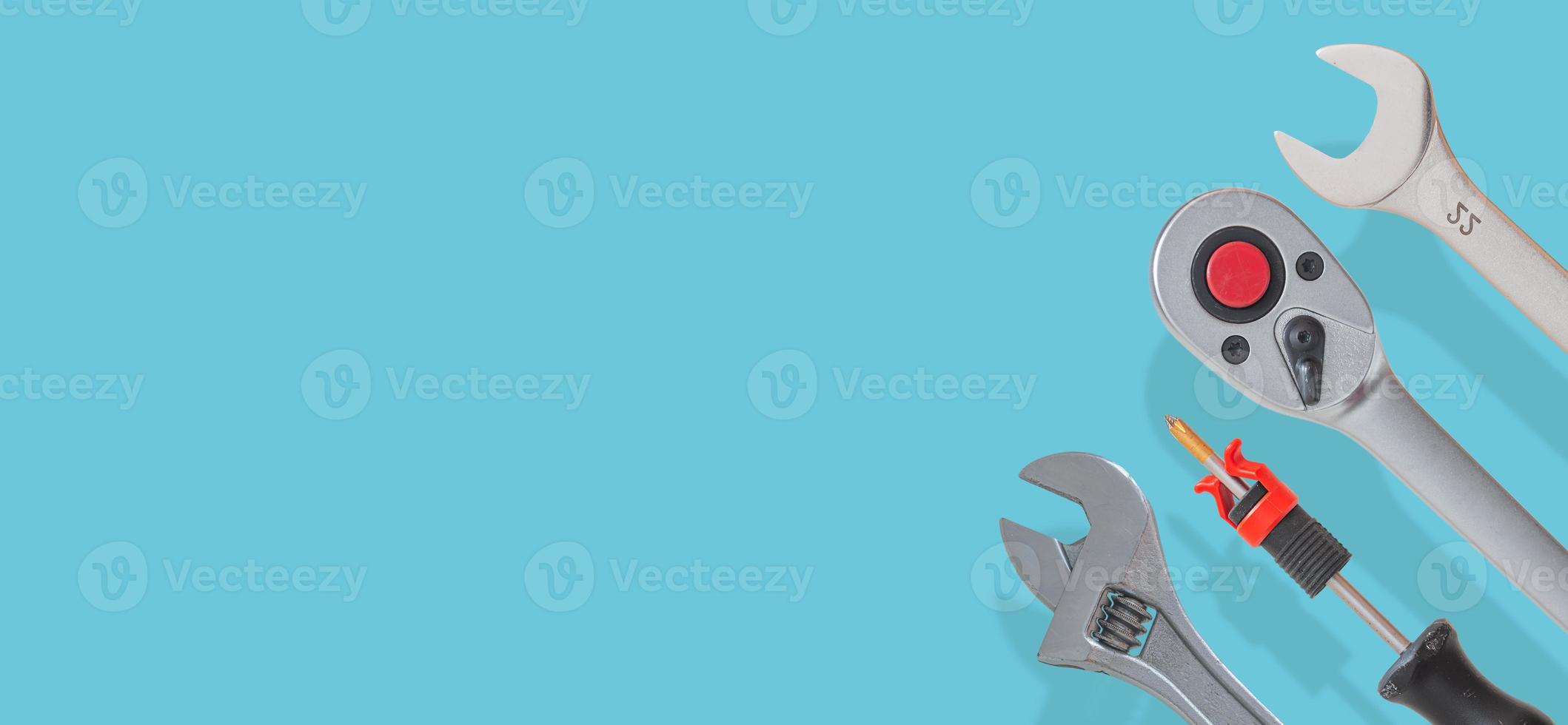 Banner with a set of workshop tools with shadows at solid turquoise background with copy space. Concept of hardware, gears, and workshop work photo