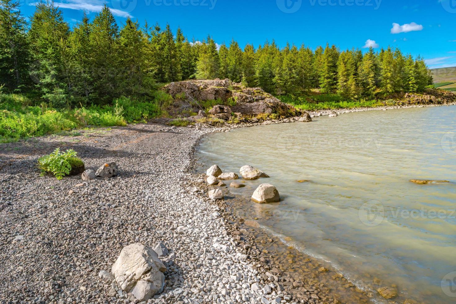 Biggest in Iceland lake called Lagarfjot at sunny day and blue cloudy sky, summer. photo