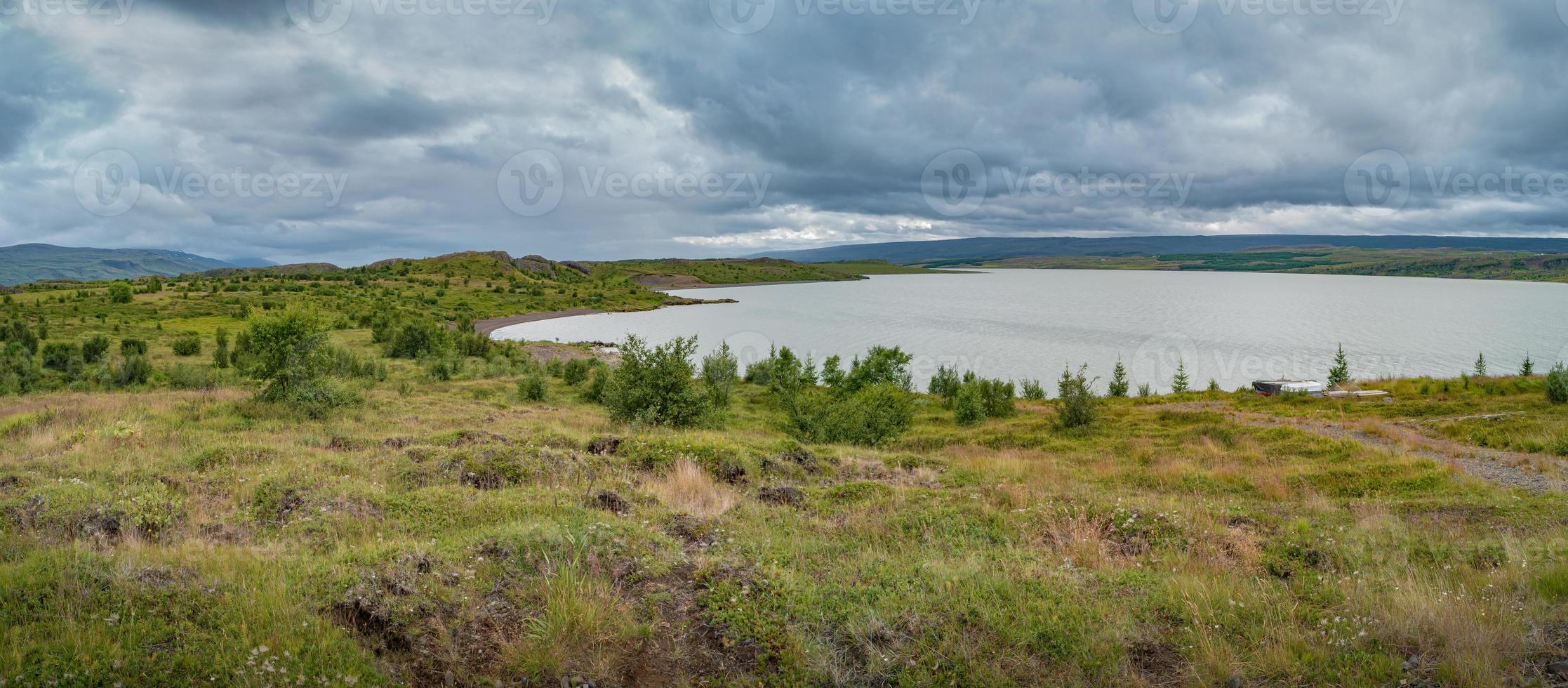 Panoramic view over huge Lagarfjot lake in Iceland at sunny day and dramatic cloudy sky, summer. photo