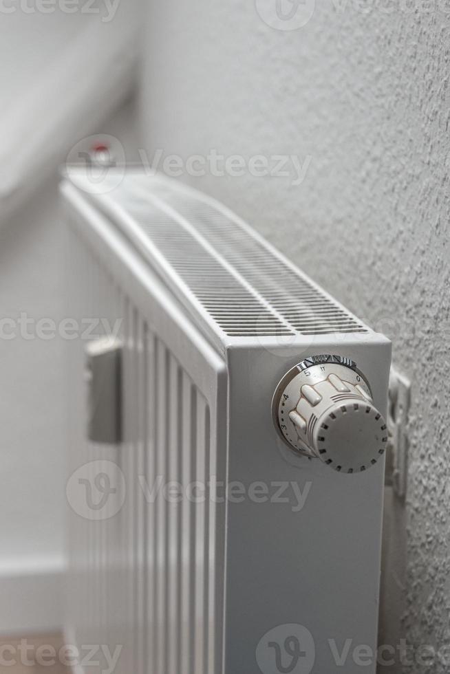 House heating battery with maximum heating power setting adjusted at its dial with copy space background. Concept of energy consumption in households. photo