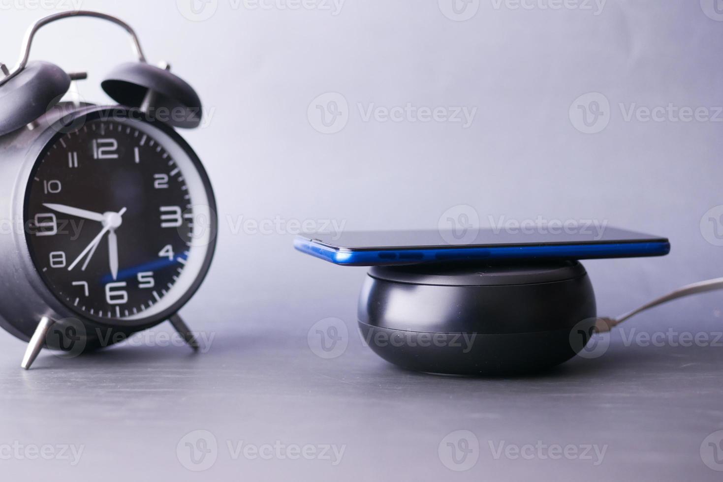 charging Smartphone using Wireless Charging Pad, top view photo