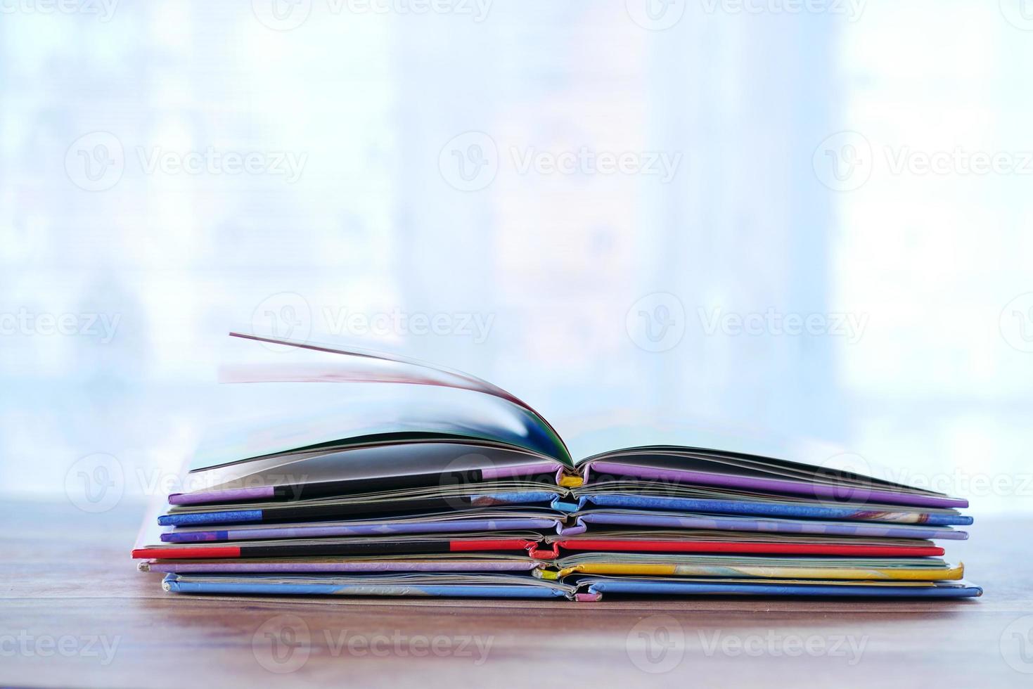 stack of colorful books on table with copy space photo