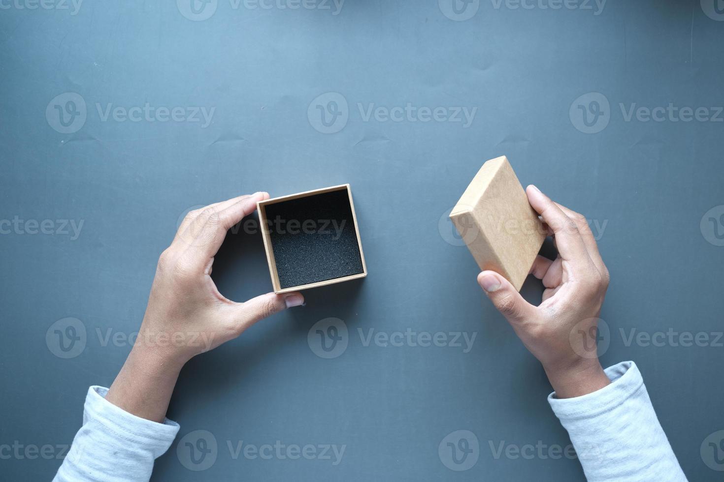 top view of person open a empty small gift box photo