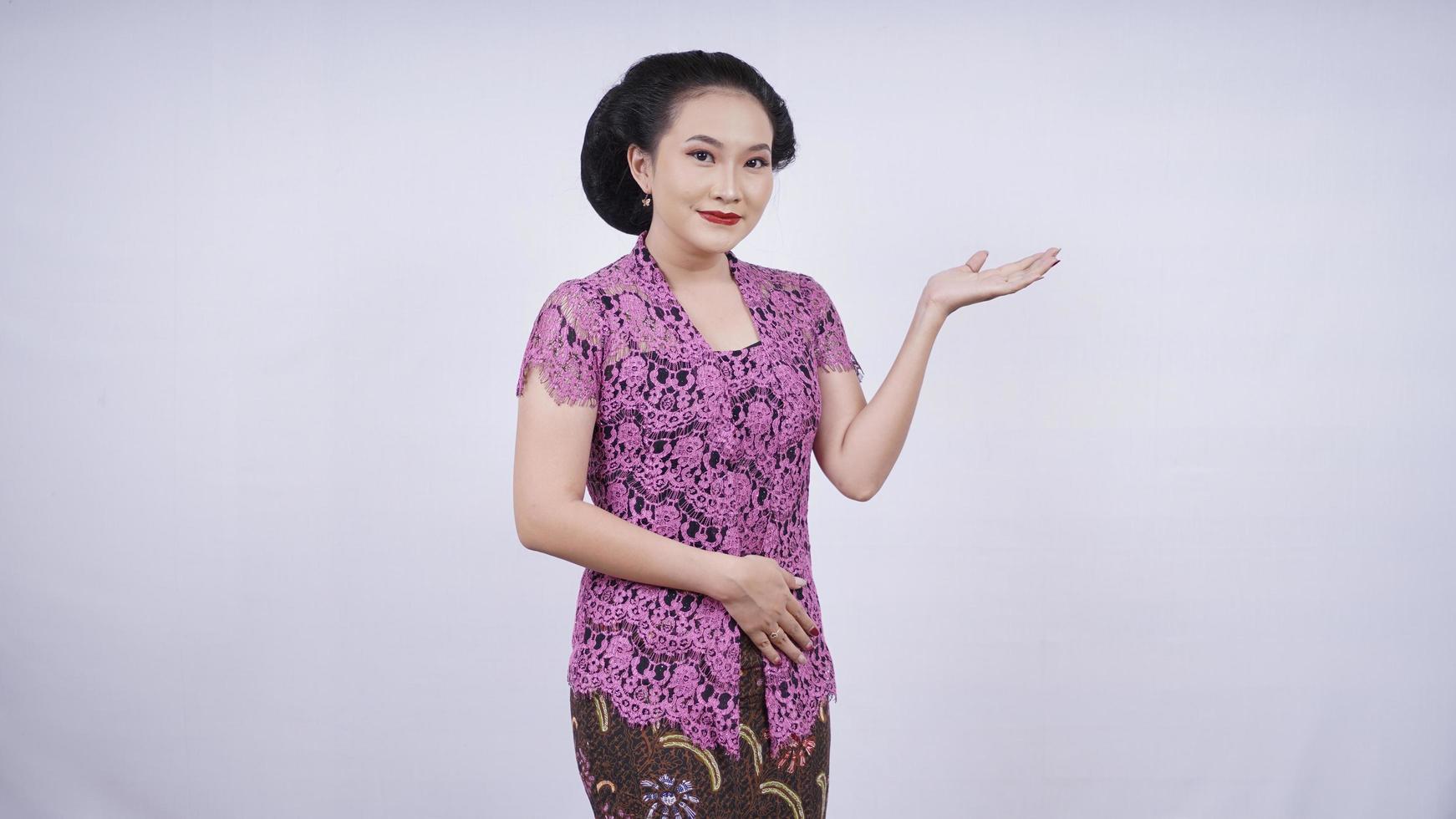 beauty in kebaya smiling pointing blankly sideways isolated on white background photo