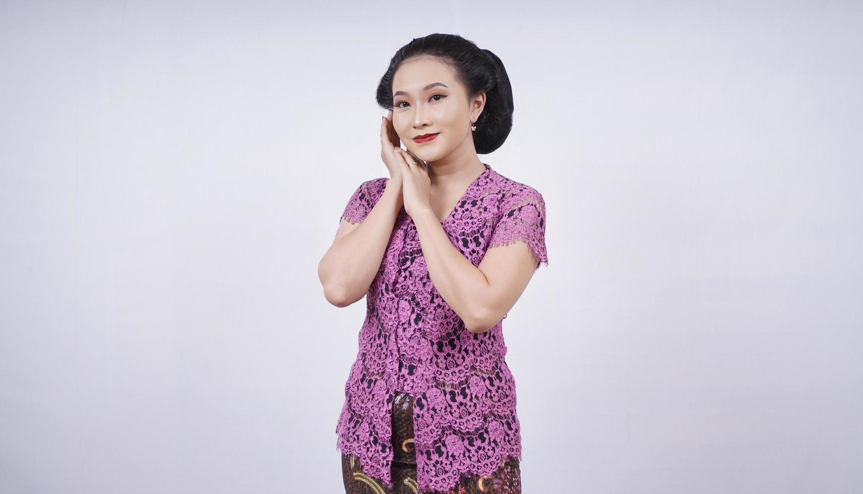 beauty in kebaya showing spoiled sweet face isolated on white background photo