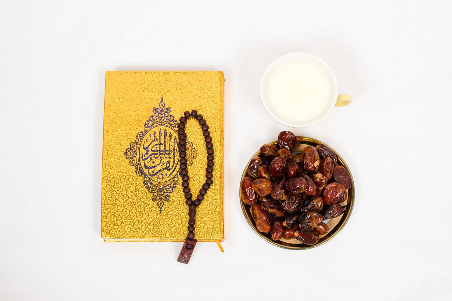 quran dates and a glass of milk isolated on a white background photo