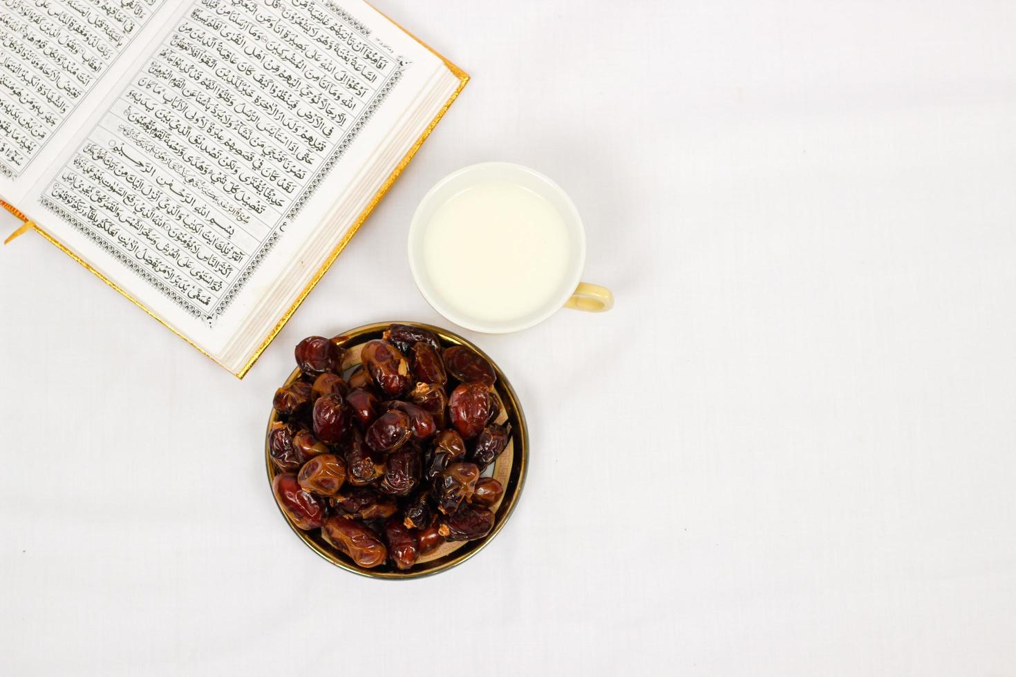 quran dates and a glass of milk isolated on a white background photo