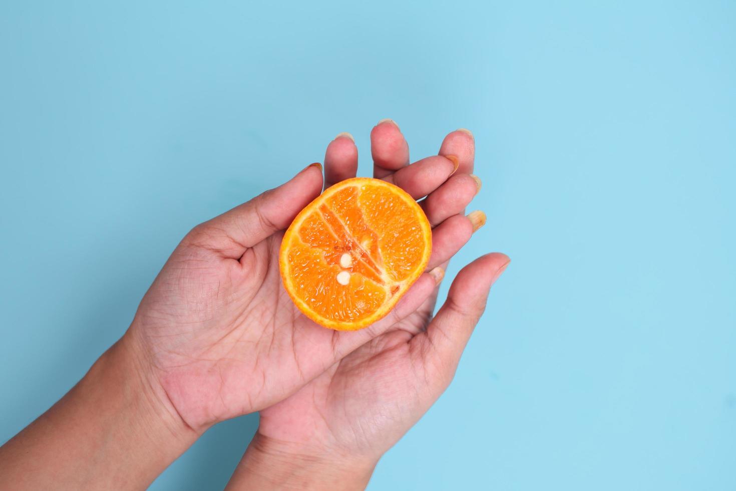 sex education with orange isolated on blue background photo