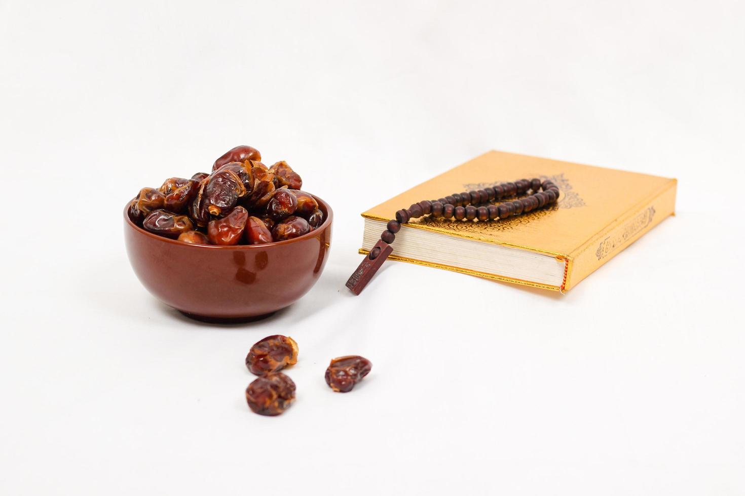 dates and quran isolated on white background photo