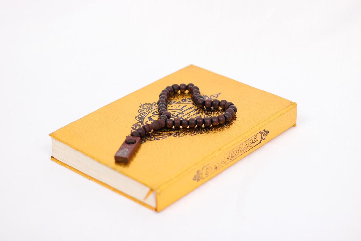 love the holy book quran and tasbih isolated on white background photo