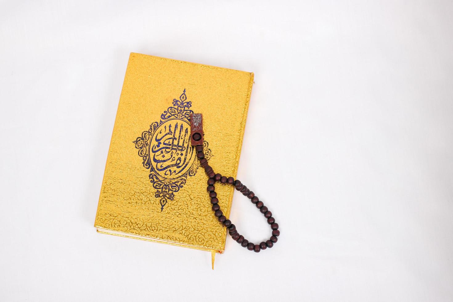 holy book quran and tasbih isolated on white background photo