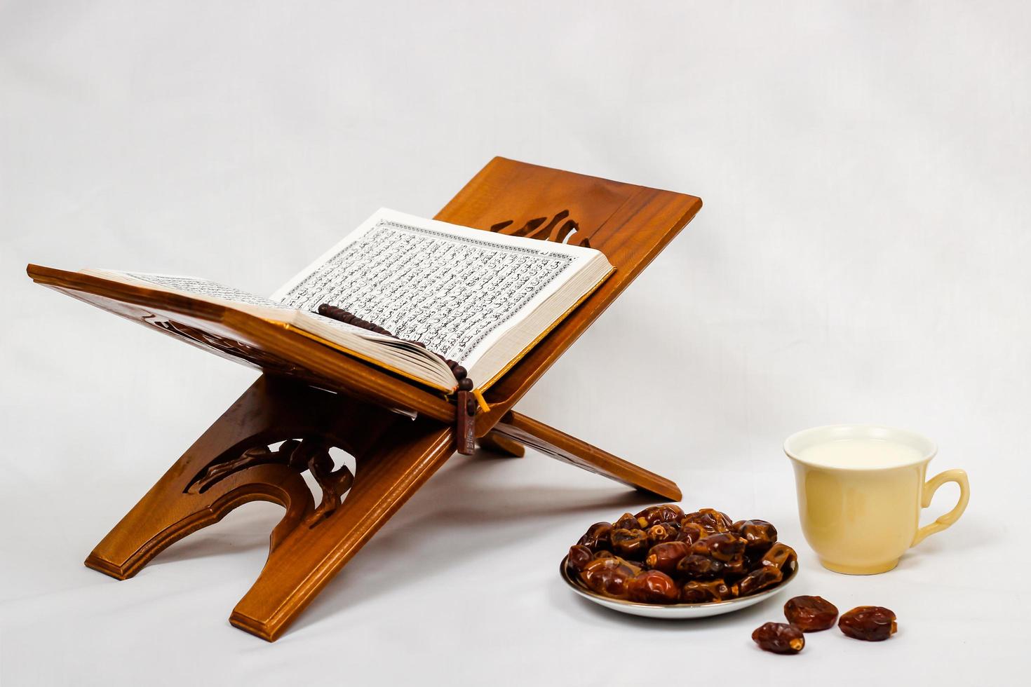 quran dates and a glass of milk isolated on a white background photo