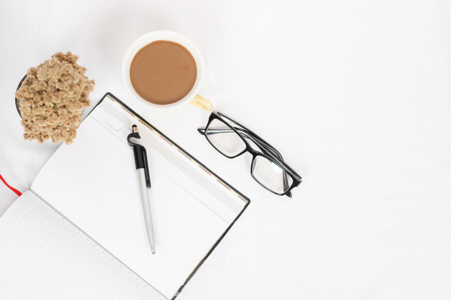 work desk with cup of coffee and notes isolated on white background photo