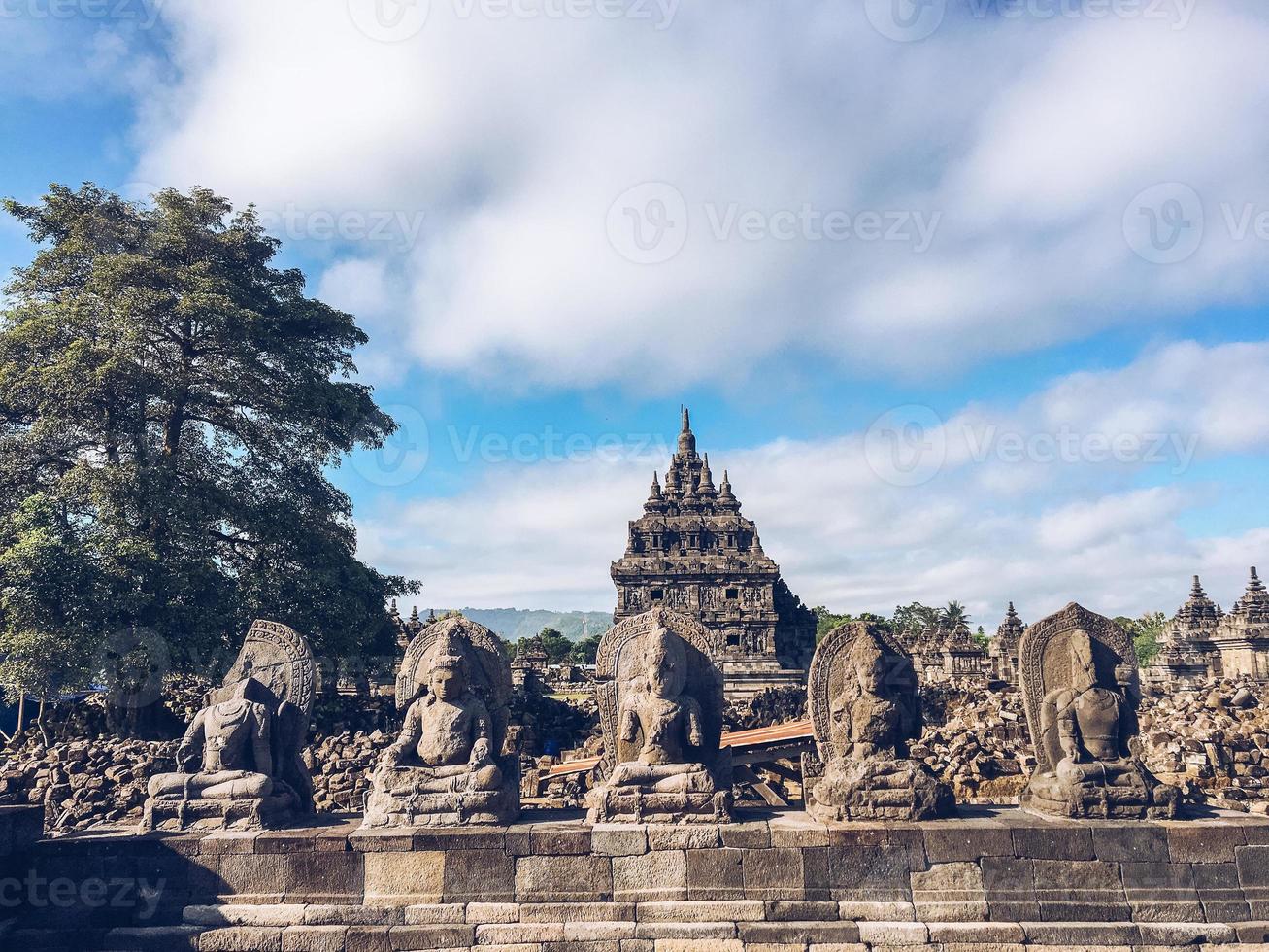 Many Buddhist statue with background of Candi Plaosan or Plaosan Temple in Plaosan Complex temple. One of the javanese Buddhist temples located Prambanan, Klaten, Central Java, Indonesia. photo