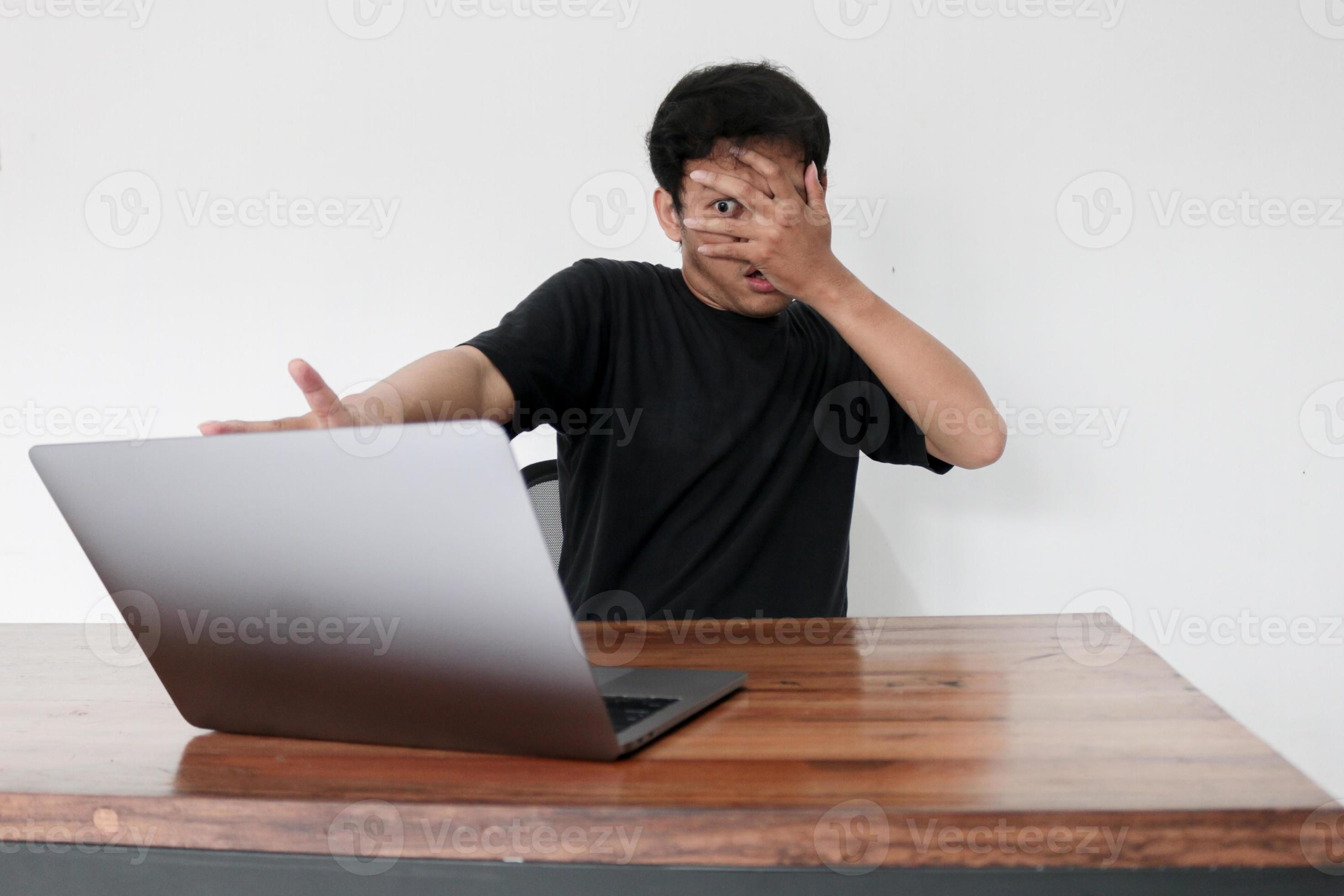 2940px x 1960px - Young asian man hiding his face with hand because shocked and embarrassed  by some porn videos or another forbidden thing he saw on the internet using  a laptop 5714831 Stock Photo at