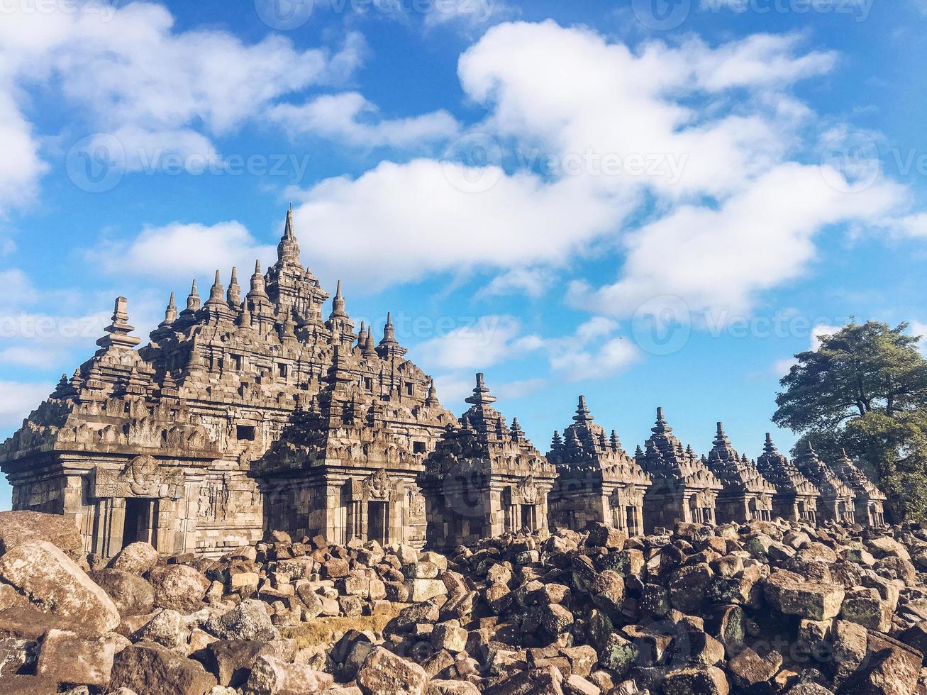 Many small Temple in Plaosan Complex temple with blue sky and sunny sun background. One of the javanese Buddhist temples located in Prambanan, Klaten, Central Java, Indonesia. photo