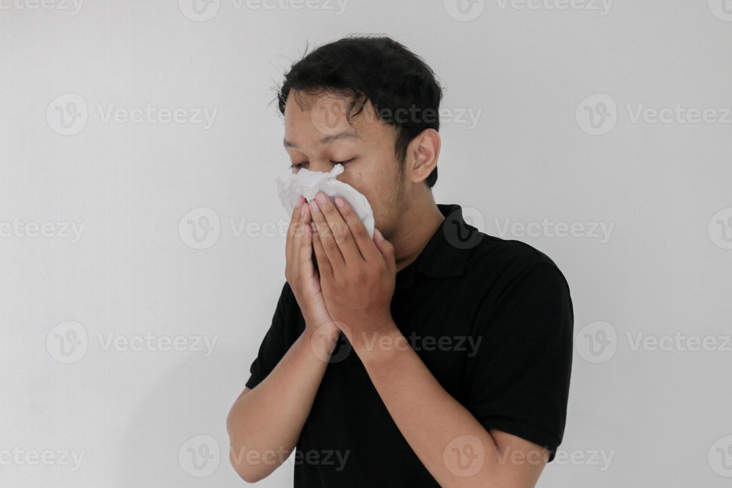 Sick asian man flu and cough is sitting with using tissue. Illness, influenza, pain concept. Healthcare and Corona Concepts photo